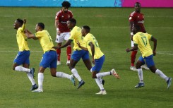 Sundown's midfielder Thapelo Maseko celebrates with teammates after scoring a goal. AFP/Phill Magakoe