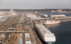 Cargo vessels and trucks are seen at the Port of Durban harbour. AFP/Rajesh Jantilal