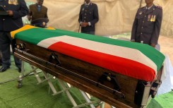 Police officers stand guard over a fallen colleague's casket. Twitter/SAPoliceService