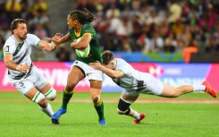 South Africa's Justin Geduld (C) is tackled during the men's HSBC World Rugby Sevens Series 2023 pool B match between South Africa and Ireland. AFP/Rodger Bosch