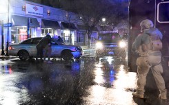 Members of the US Secret Service rush to a car after it hit a motorcade SUV as US president Joe Biden was leaving his campaign headquarters in Wilmington. AFP/Andrew Caballero-Reynolds