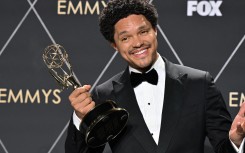 South African comedian Trevor Noah poses in the press room with the Outstanding Talk Series award for "The Daily Show With Trevor Noah". AFP/Robyn Beck