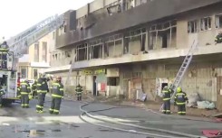 Firefighters on the scene of the building fire in the Joburg CBD.