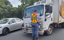 A police officer at a vehicle during Operation Shanela. eNCA/Bafedile Moerane