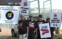 Protesters with signs against human trafficking.