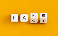 Fake news illustration, fake fact dice concept. Getty Images/Anton Melnyk