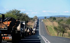 File: A line of trucks along the N4 highway. Leon Sadiki/Bloomberg via Getty Images