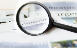 The word corruption seen on a piece of paper. Getty Images/TheaDesign