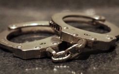 File: A pair of handcuffs on a table. Getty Images/James C Hooper