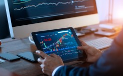 File: A businessman checking the stock market. Getty Images/ipopba