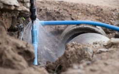 File: An exposed burst water pipe spraying water.GettyImages/24d8bd43_811