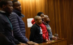 Five accused men in the Senzo Mayiwa murder trial stand in the dock at Pretoria High Court. Phill Magakoe/Gallo Images via Getty Images