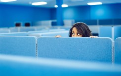 File: An office worker eavesdropping in cubicle room. Getty Images/ferrantraite