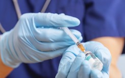 File: A healthcare worker fills a syringe with a vaccine. GettyImages/Andril Zorii