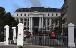 File: Firefighters extinguish the fire broke out at Parliament. Xabiso Mkhabela/Anadolu Agency via Getty Images