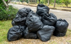 File: Black garbage bags on the pavement. GettyImages/Byjeng