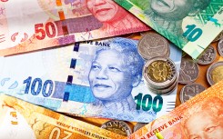 File: South African banknotes with Five Rand and Two Rand coins. GettyImages/RapidEye