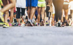 File: A crowd of people walking and running. GettyImages/VTT Studio