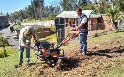 Emerging farmers with machinery