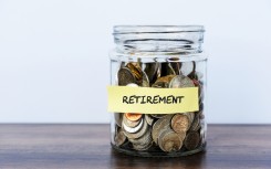 A bottle filled with coins for retirement. GettyImages/Nora Carol Photography