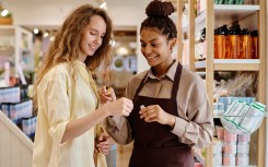 File: Saleswoman helping a customer in a cosmetics store. GettyImages/AnnaStills