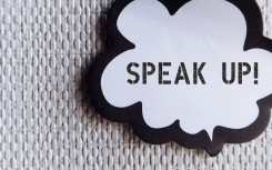 Word ballon on wallpaper with text SPEAK UP. GettyImages/ariya j