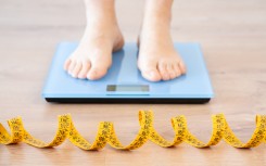 File: A person standing on a scale. Weight loss. GettyImages/Cunaplus_M.Faba