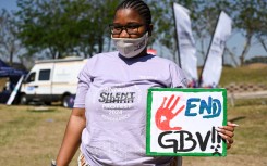 File: A student with End GBV sign at the 10th Annual Silent Protest March. Darren Stewart/Gallo Images via Getty Images