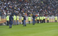 Unruly fans invaded the pitch during the first half of the game. BackpagePix/Deryck Foster