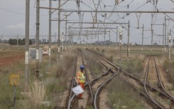 A worker prepares to signal on the train tracks on the central corridor rail freight line. Guillem Sartorio/Bloomberg via Getty Images