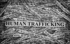 File: Torn pieces of paper with the words Human Trafficking. GettyImages/Professor25