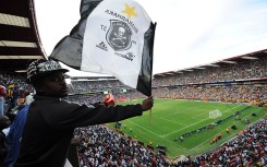 File: A fan waving an Orlando Pirates flag. Lefty Shivambu/Gallo Images/Getty Images