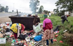 Women look for recyclable items in a garbage container on the streets in Mthatha. Per-Anders Pettersson/Getty Images