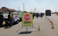 Police officers monitoring a roadblock. Twitter/@SAPoliceService