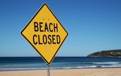 File: A Beach Closed sign. GettyImages/Cameron Spencer