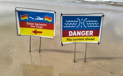 Warnings for swimming conditions on a beach. eNCA/Ronald Masinda