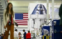 Officials and media personnel are seen inside the Operations and Checkout Building (O&C) at the Kennedy Space Center in Cape Canaveral, Florida