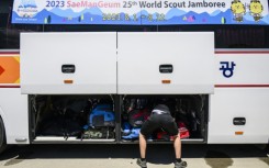 Scouts prepare to leave the  World Scout Jamboree camspite in South Korea's North Jeolla province, which has been plagued by problems and is being evacuated as a typhoon approaches