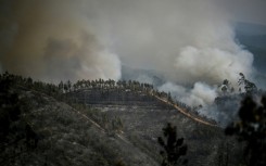 Columns of smoke rise from wildfire in Odeceixe, southern Portugal, as temperatures soar there and in neighbouring Spain