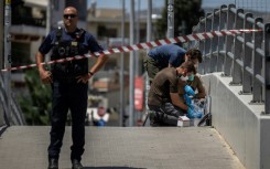 Greek police search for evidence after the fatal stabbing of a fan which saw the Champions League qualifier between AEK Athens and Dinamo Zagreb postponed