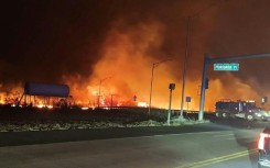 Flames from a Hawaii wildfire stoked by hurricane winds threatened parts of Lahaina, on the island of Maui, and forced evacuations 