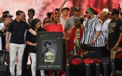 US rapper DJ Kool Herc (R) recieves the Cultural Impact Award during the Hip Hop 50 Live concert, which marked five decades of the genre