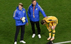 Sweden coach Peter Gerhardsson (C) consoles captain Kosovare Asllani after the World Cup semi-final defeat against Spain