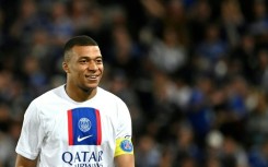 Kylian Mbappe looks on from the stands in Paris Saint-Germain's season opener after being left out over a contract dispute