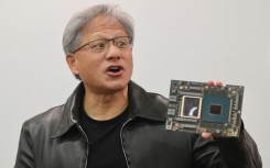 Nvidia CEO Jensen Huang with one of the firm's processors -- prized for building AI applications