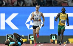 Bahamas' Steven Gardiner crashes to the track