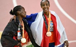 Sifan Hassan (R) stands with Faith Kipyegon