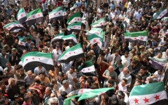 Syrians in the rebel-held northern city of Azaz demonstrate in solidarity with the protesters in the government-ruled south