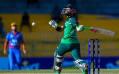 One hand or two? Pakistan's Mohammad Rizwan plays a shot