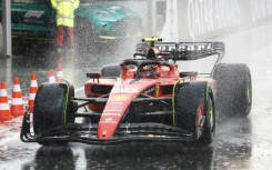 Wet, wet, wet: Ferrari's Carlos Sainz drives in the pit lane